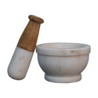 mortar and pestle, meticulously handcrafted from natural white marble and paired with a smooth wooden-accent handle